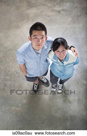 Young adults looking up View Large Photo Image Stock Photograph - Young adults looking up. Fotosearch