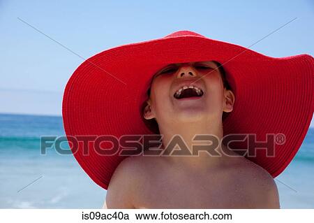 Young boy in large red sunhat View Large Photo Image Stock Image - Young boy in large red sunhat. Fotosearch