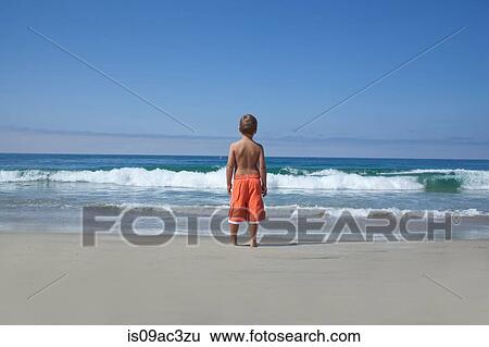 Young boy looking out to sea View Large Photo Image Stock Photograph - Young boy looking out to sea. Fotosearch