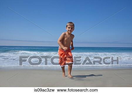 Young boy running on beach View Large Photo Image Stock Photo - Young boy running on beach. Fotosearch
