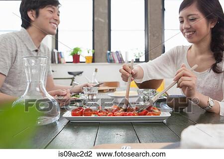 Young couple having lunch at table View Large Photo Image Stock Image - Young couple having lunch at table. Fotosearch