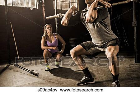Young man and personal trainer working out in gym View Large Photo Image Stock Photo - Young man and personal trainer working out in gym. Fotosearch