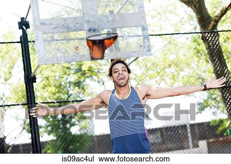 Young man celebrating on basketball court View Large Photo Image Stock Image - Young man celebrating on basketball court. Fotosearch
