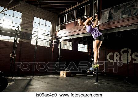 Young woman exercising on gymnastic ring View Large Photo Image Stock Image - Young woman exercising on gymnastic ring. Fotosearch