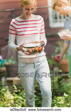Young woman holding sieve with tomatoes View Large Photo Image Stock Image - Young woman holding sieve with tomatoes. Fotosearch