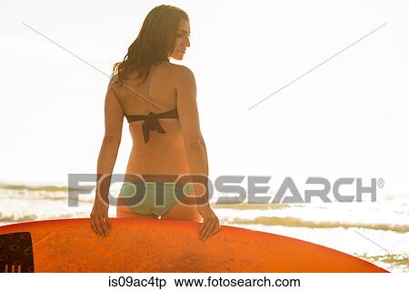Stock Photography - Young woman holding surfboard, La Jolla, San Diego, California, USA. Fotosearch
