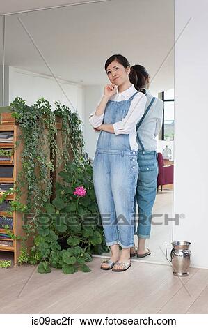 Young woman in living room thinking View Large Photo Image Stock Photography - Young woman in living room thinking. Fotosearch