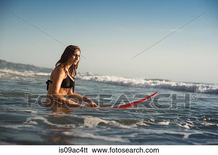 Stock Photograph - Young woman in sea with surfboard, La Jolla, San Diego, California, USA. Fotosearch