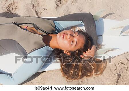Young woman sunbathing on surfboard, Hermosa Beach, California, USA View Large Photo Image Stock Image - Young woman sunbathing on surfboard, Hermosa Beach, California, USA. Fotosearch