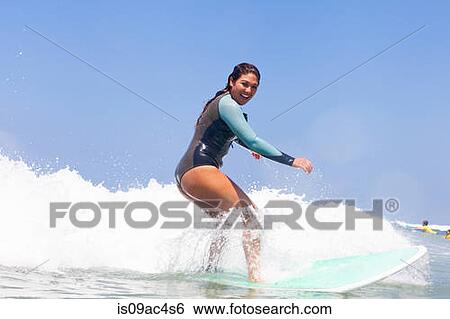 Stock Photograph - Young woman surfing, Hermosa Beach, California, USA. Fotosearch