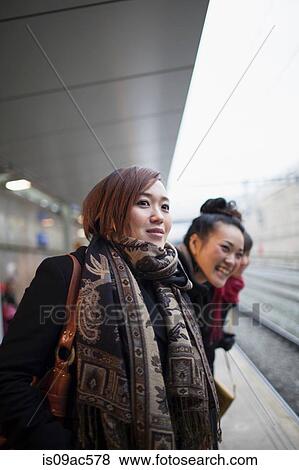 Young women waiting for train View Large Photo Image Stock Photo - Young women waiting for train. Fotosearch