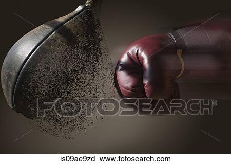 Stock Image - Close up boxer and punch bag with blurred motion. Fotosearch