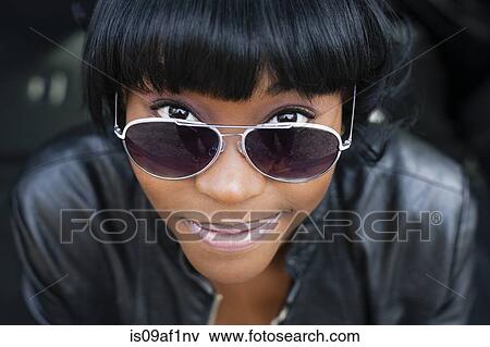 Stock Photo - Close up portrait of young woman in sunglasses. Fotosearch