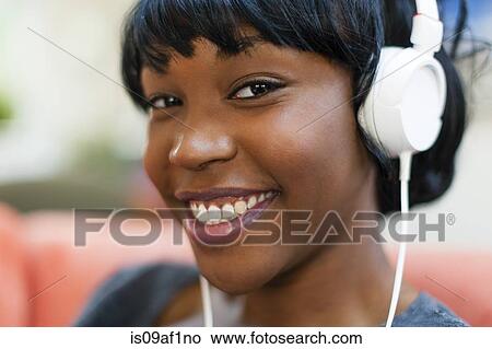 Picture - Close up portrait of young woman wearing headphones. Fotosearch