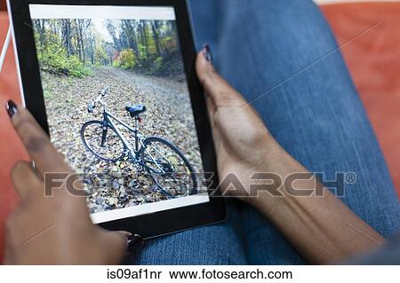 Cropped image of young woman using digital tablet View Large Photo Image Stock Photography - Cropped image of young woman using digital tablet. Fotosearch