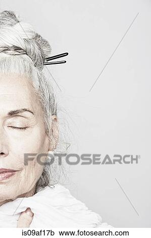 Cropped studio portrait of senior woman with eyes closed View Large Photo Image Stock Image - Cropped studio portrait of senior woman with eyes closed. Fotosearch