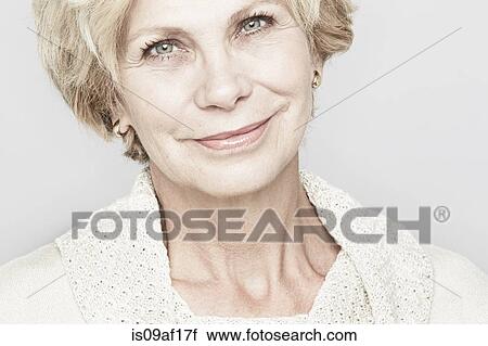 Stock Image - Cropped studio portrait of senior woman smiling. Fotosearch