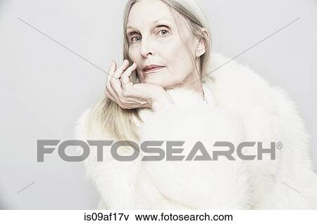 Cropped studio portrait of senior woman with hand on chin View Large Photo Image Stock Photo - Cropped studio portrait of senior woman with hand on chin. Fotosearch