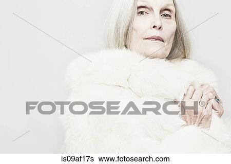 Cropped studio portrait of senior woman in white fur coat View Large Photo Image Stock Photograph - Cropped studio portrait of senior woman in white fur coat. Fotosearch