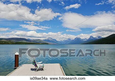 Stock Image - Deckchair on jetty, lake McDonald, Glacier National Park, Montana, USA. Fotosearch