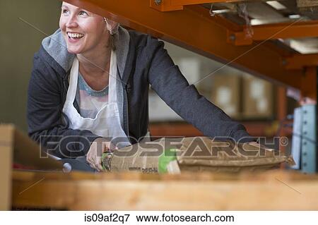 Factory worker handling parcel View Large Photo Image Stock Photo - Factory worker handling parcel. Fotosearch