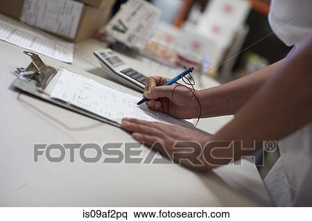 Stock Photography - Factory worker with clipboard, close up. Fotosearch