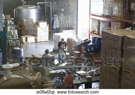 Factory workers in distribution warehouse View Large Photo Image Stock Photograph - Factory workers in distribution warehouse. Fotosearch