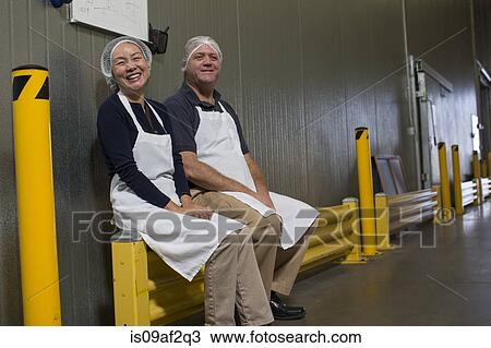 Stock Image - Factory workers taking a break. Fotosearch
