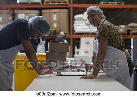 Factory workers with paperwork View Large Photo Image Picture - Factory workers with paperwork. Fotosearch