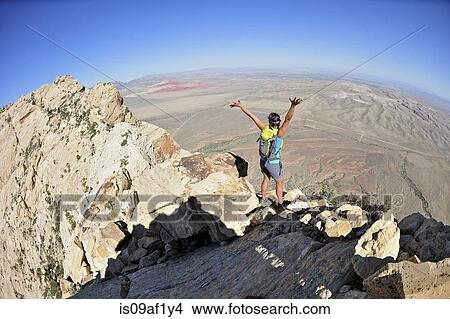 Female hiker celebrating on ridge, Mount Wilson, Red Rock Canyon, Nevada, USA View Large Photo Image Picture - Female hiker celebrating on ridge, Mount Wilson, Red Rock Canyon, Nevada, USA. Fotosearch