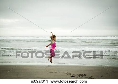Female toddler jumping on beach View Large Photo Image Stock Image - Female toddler jumping on beach. Fotosearch