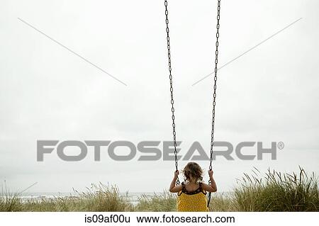 Female toddler on beach swing View Large Photo Image Stock Photograph - Female toddler on beach swing. Fotosearch