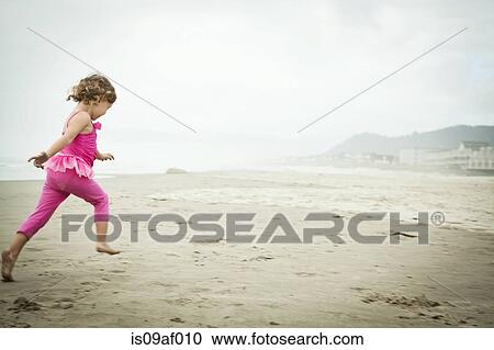 Female toddler running on beach View Large Photo Image Stock Image - Female toddler running on beach. Fotosearch