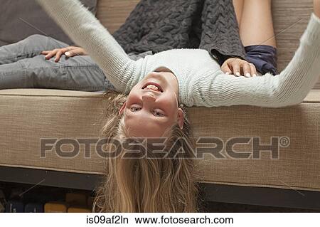 Girl upside down on sofa View Large Photo Image Picture - Girl upside down on sofa. Fotosearch