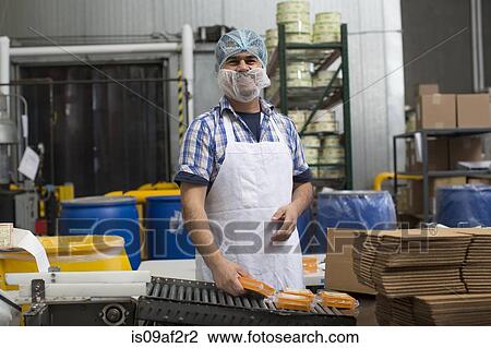 Man packaging vegan cheese in warehouse View Large Photo Image Stock Image - Man packaging vegan cheese in warehouse. Fotosearch