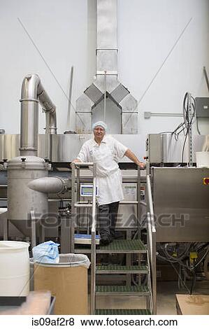 Man standing on steps in food production factory View Large Photo Image Stock Photo - Man standing on steps in food production factory. Fotosearch
