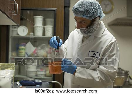 Man whisking liquid in food research laboratory View Large Photo Image Stock Photo - Man whisking liquid in food research laboratory. Fotosearch