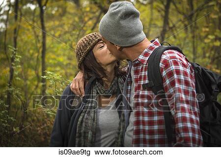 Mature couple kissing in forest View Large Photo Image Stock Image - Mature couple kissing in forest. Fotosearch