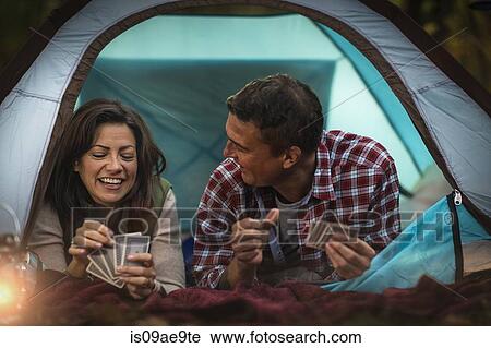 Mature couple lying together in tent, playing card game View Large Photo Image Stock Image - Mature couple lying together in tent, playing card game. Fotosearch