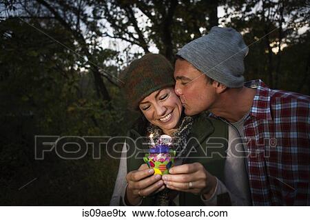 Mature couple outside tent holding birthday cupcake View Large Photo Image Stock Photo - Mature couple outside tent holding birthday cupcake. Fotosearch