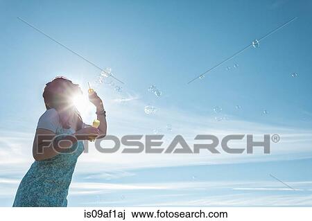 Mature woman blowing bubbles View Large Photo Image Stock Image - Mature woman blowing bubbles. Fotosearch