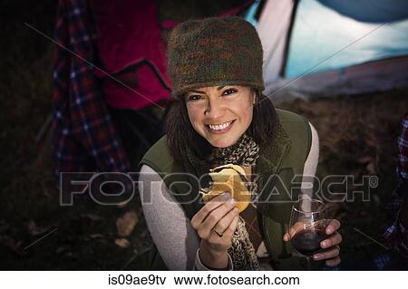 Mature woman holding burger and glass of wine View Large Photo Image Stock Photo - Mature woman holding burger and glass of wine. Fotosearch