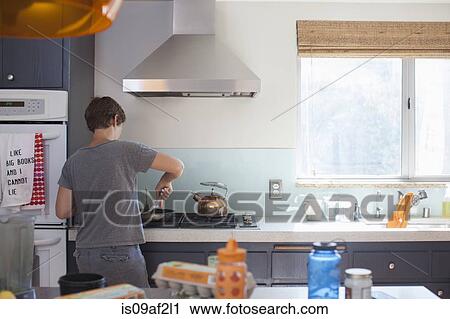 Mature woman preparing food in kitchen View Large Photo Image Stock Image - Mature woman preparing food in kitchen. Fotosearch