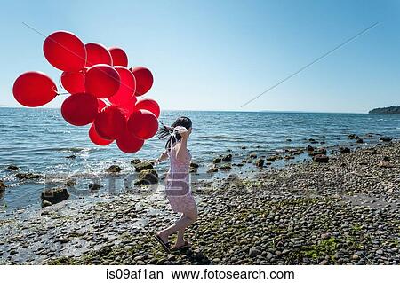Mature woman pulling bunch of balloons View Large Photo Image Picture - Mature woman pulling bunch of balloons. Fotosearch