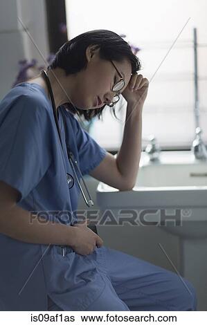 Portrait of a stressed young female doctor in office View Large Photo Image Stock Photograph - Portrait of a stressed young female doctor in office. Fotosearch