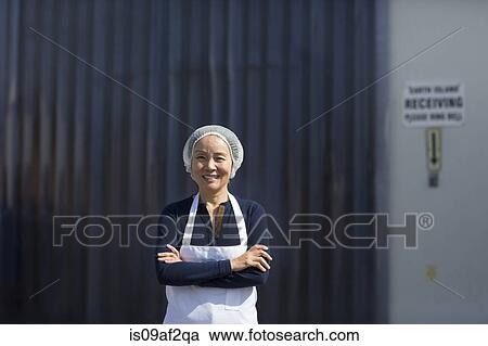 Portrait of female factory worker, arms folded View Large Photo Image Stock Image - Portrait of female factory worker, arms folded. Fotosearch