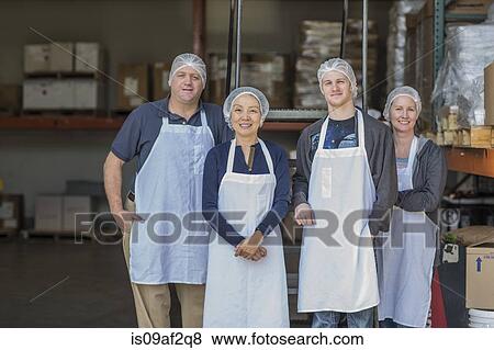 Portrait of four factory workers smiling View Large Photo Image Stock Photo - Portrait of four factory workers smiling. Fotosearch