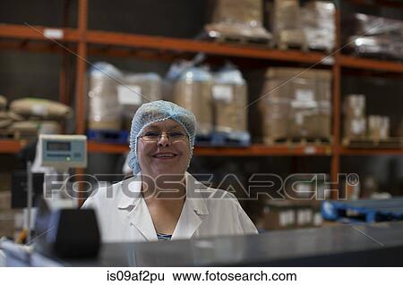 Portrait of mature factory worker, smiling View Large Photo Image Stock Photograph - Portrait of mature factory worker, smiling. Fotosearch