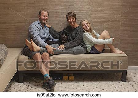 Portrait of parents and daughter on sofa View Large Photo Image Picture - Portrait of parents and daughter on sofa. Fotosearch