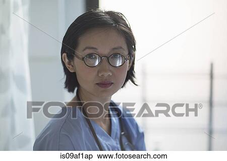 Stock Photography - Portrait of young female doctor in office. Fotosearch